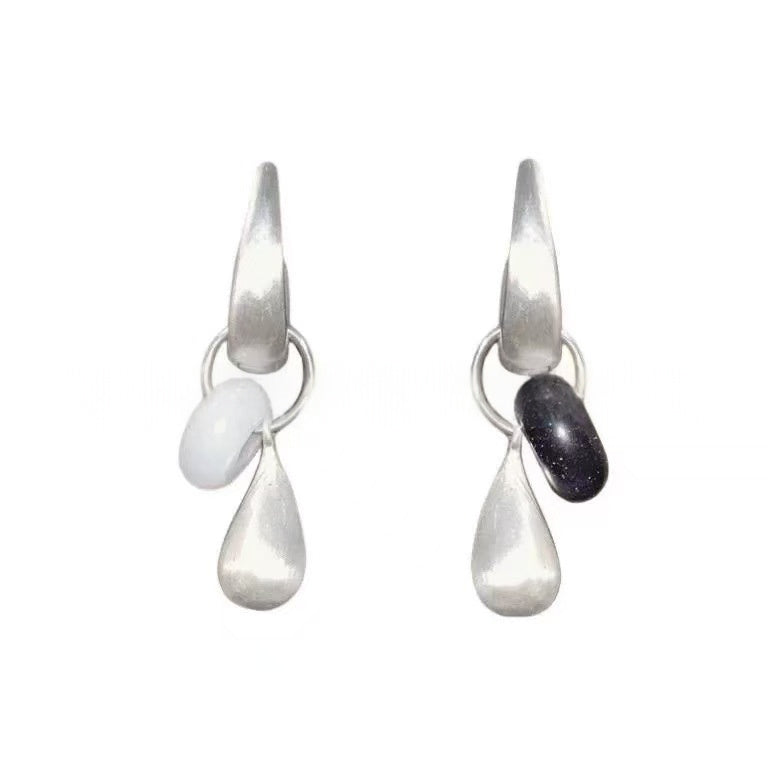 Dew Teardrop Charm Hoop Earrings styled on the ear with a plain black outfit