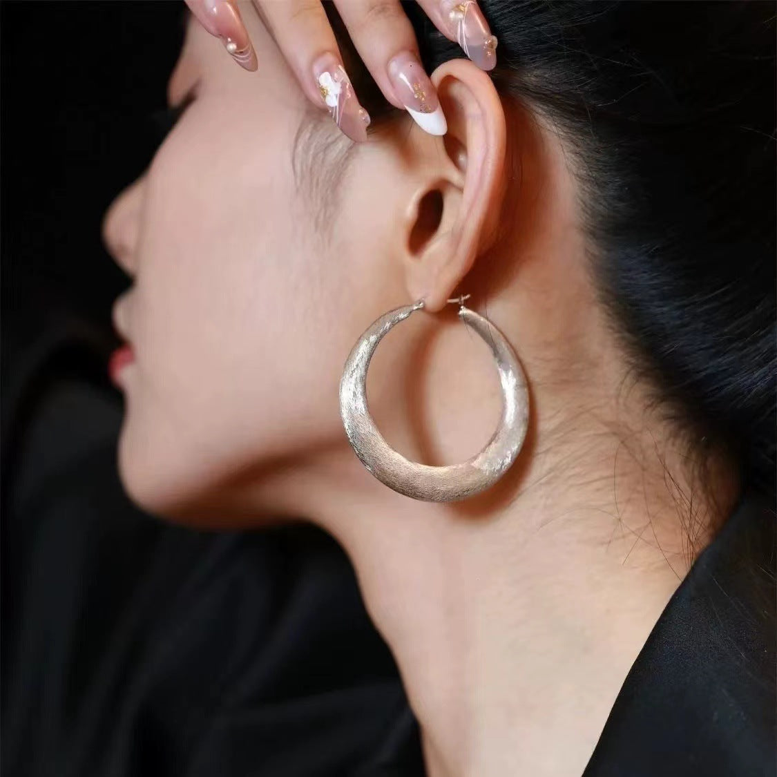 Hammered hoop earrings from Lil Cacti: the Tide Hammered Hoop Earrings shown from the side