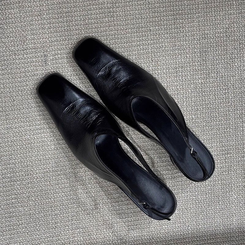 Mirelle black slingback heels front view showing round toe silhouette