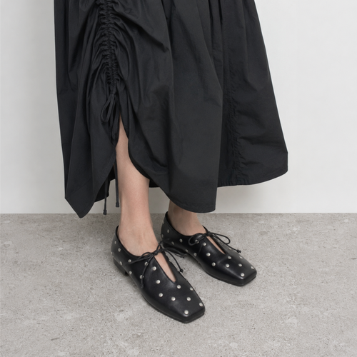 Adora Square Toe Studded Ballet Flats by Lil Cacti — on-model three-quarter view styled with a black ruched midi skirt