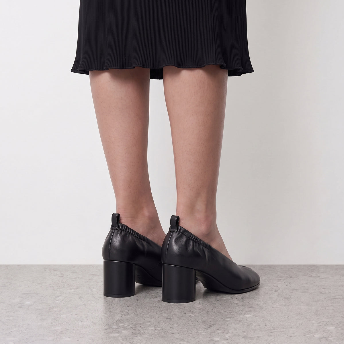 Model standing in Lil Cacti Amelora black tabi heels