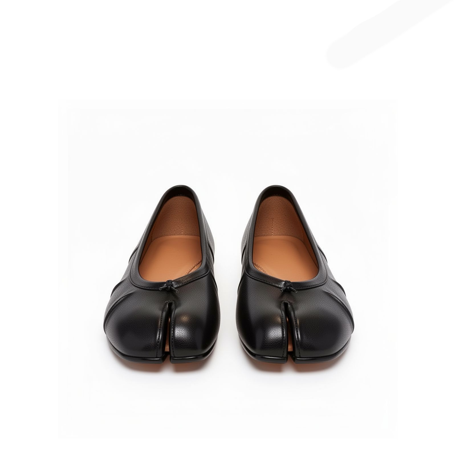 Close-up of tabi split-toe detail on Amelora black leather ballet flats