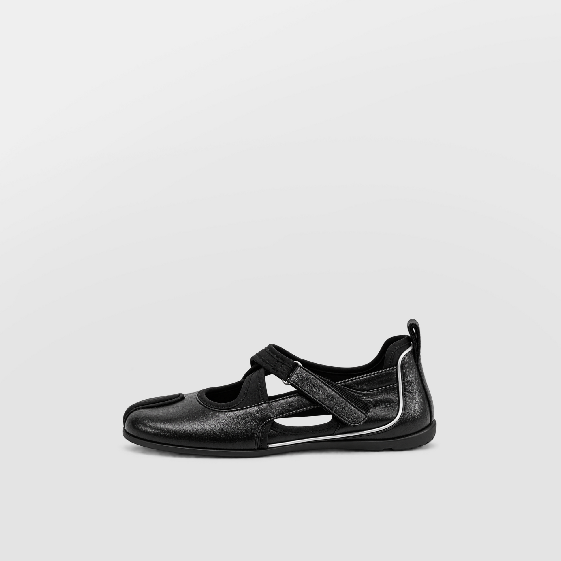 Angled view of black leather cross strap tabi flats on a pale grey ground