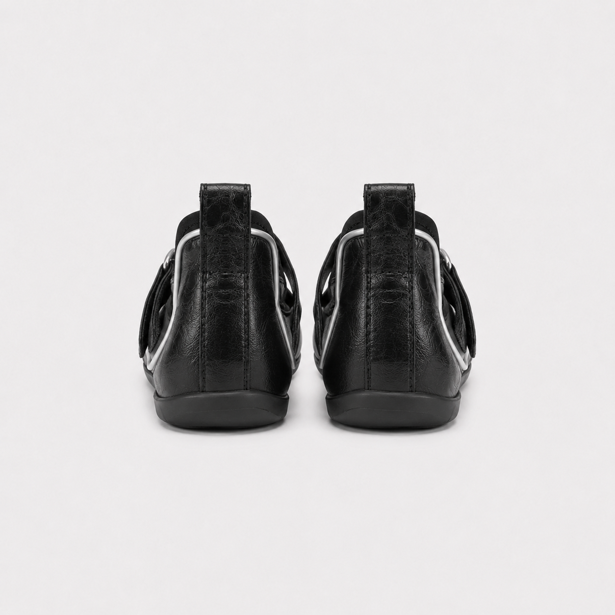 Pair of Lil Cacti black leather tabi ballet flats photographed from above