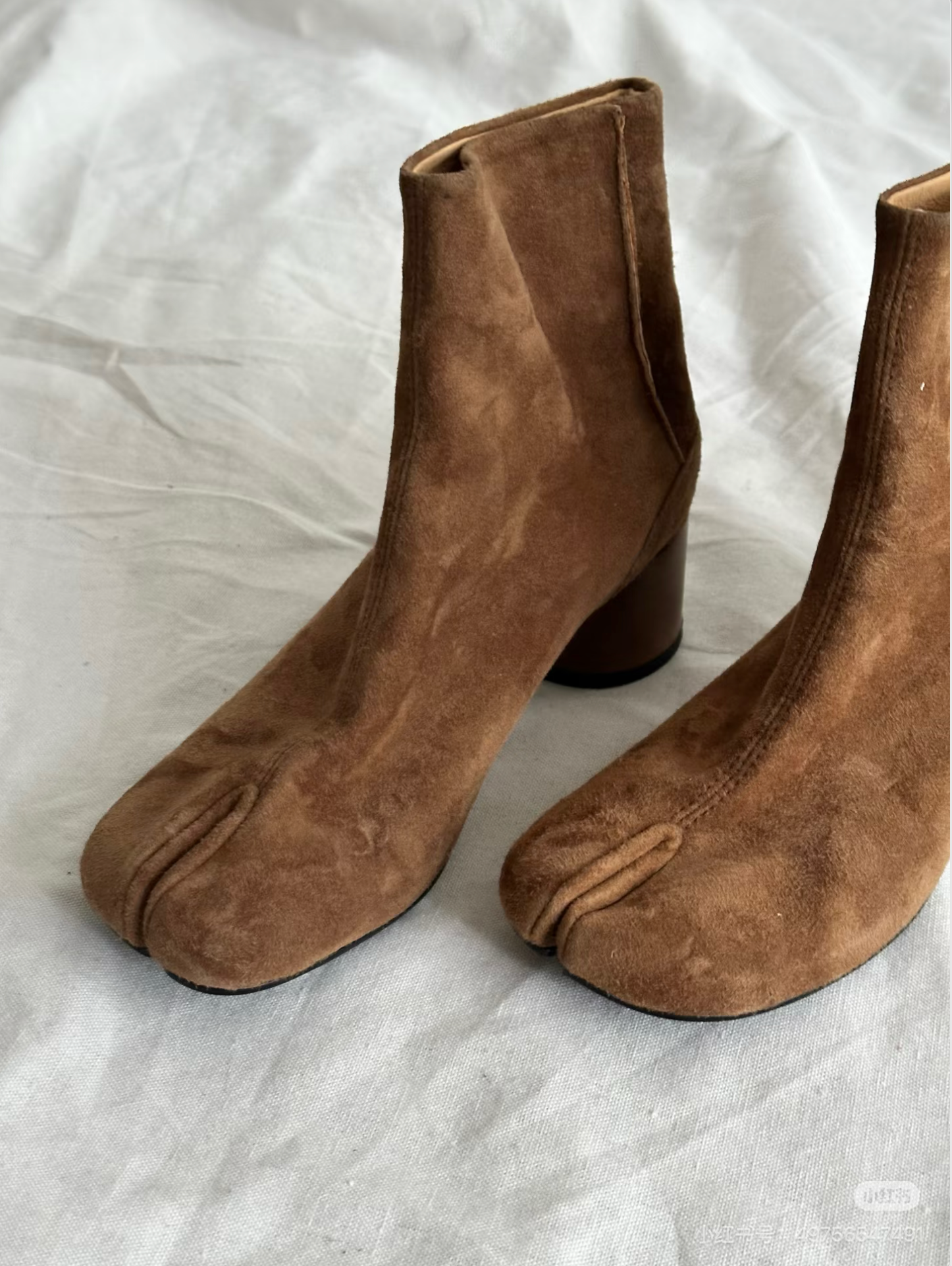 Close-up of tabi split-toe detail on Aurelia brown frosted suede boots