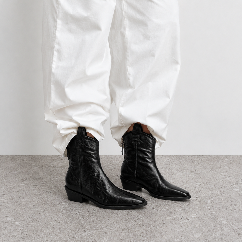 Side view of a single black western ankle boot with chunky stacked heel