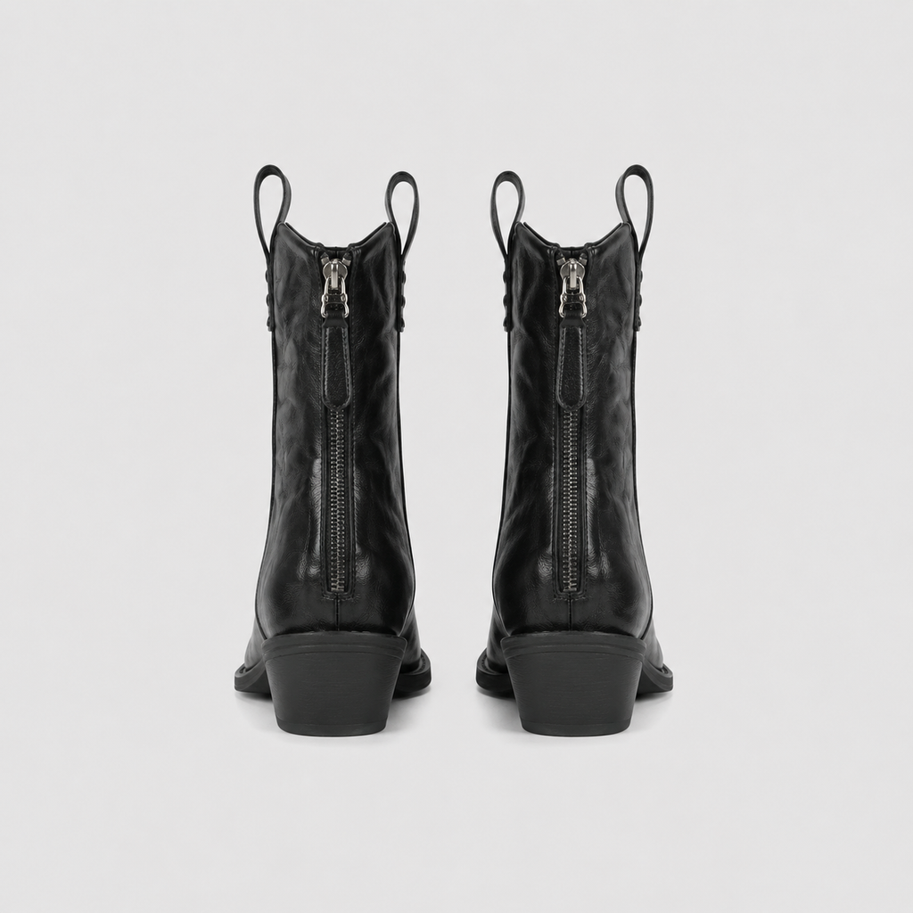 Brown pointed toe western boots angled to show the creased upper finish
