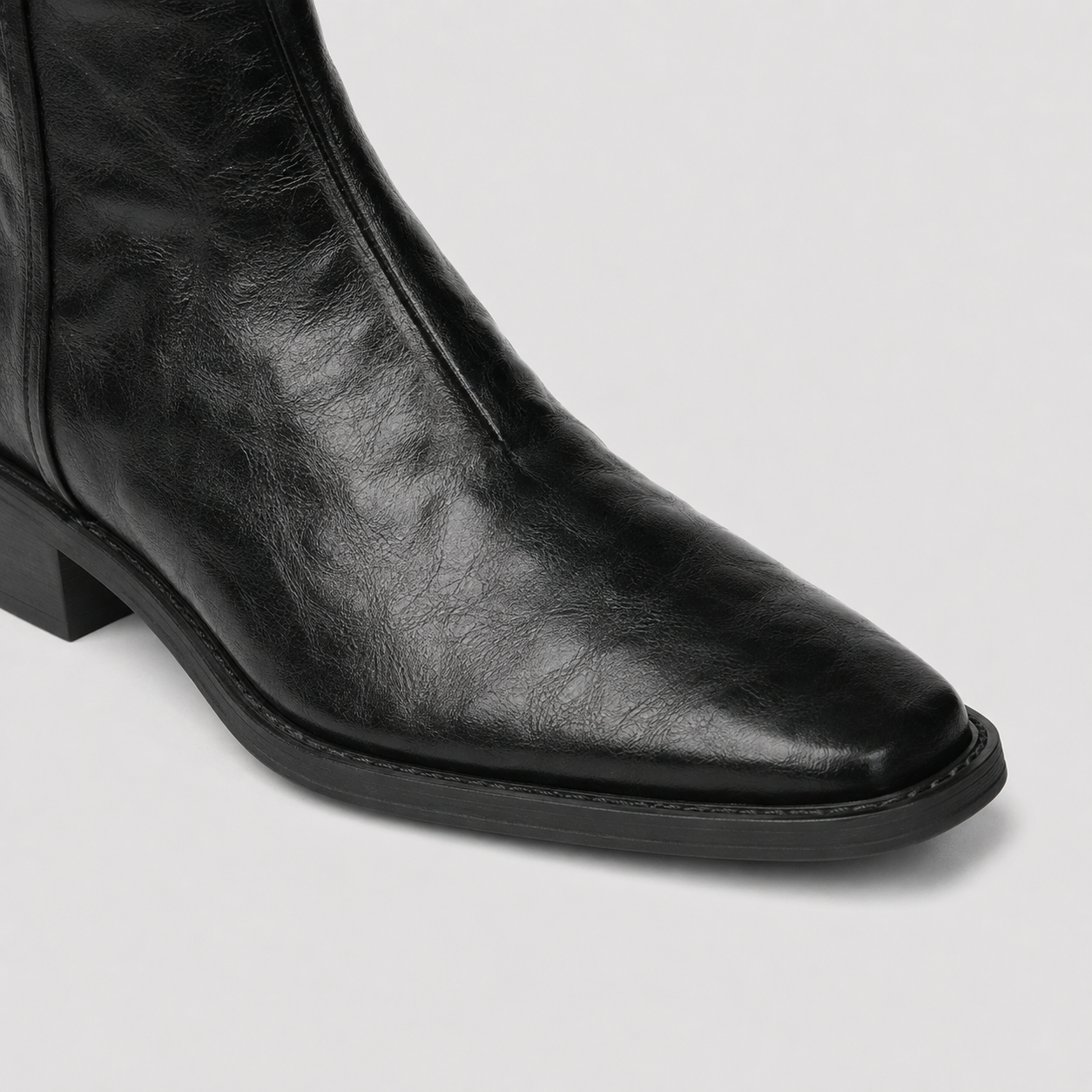 Black Lil Cacti western ankle boots photographed from above on pale flooring