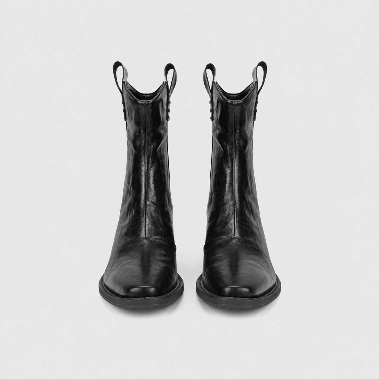Detail views of the pointed toe, stitched sole edge and back pull tab