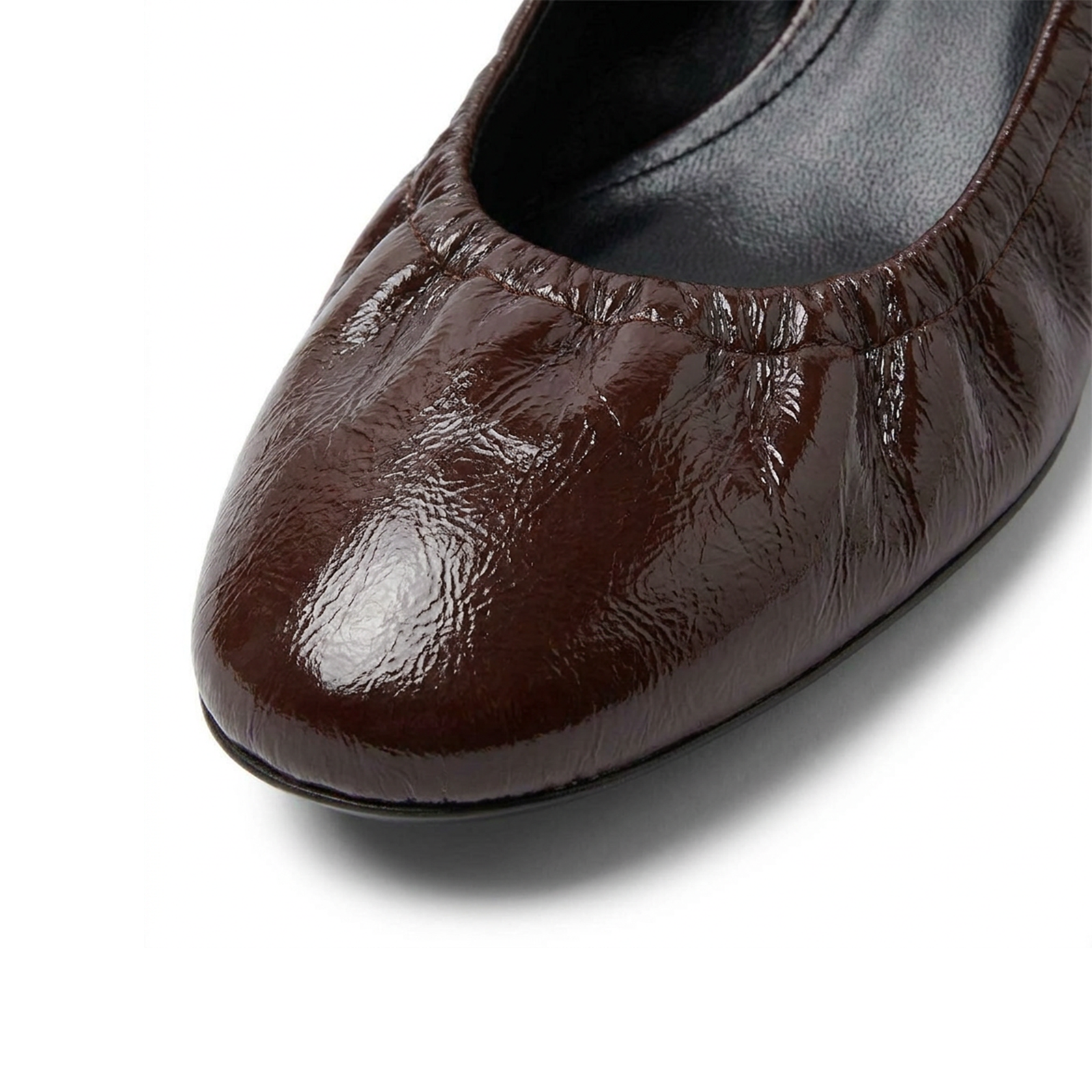 Cerise patent leather pumps styled — quiet luxury dressing