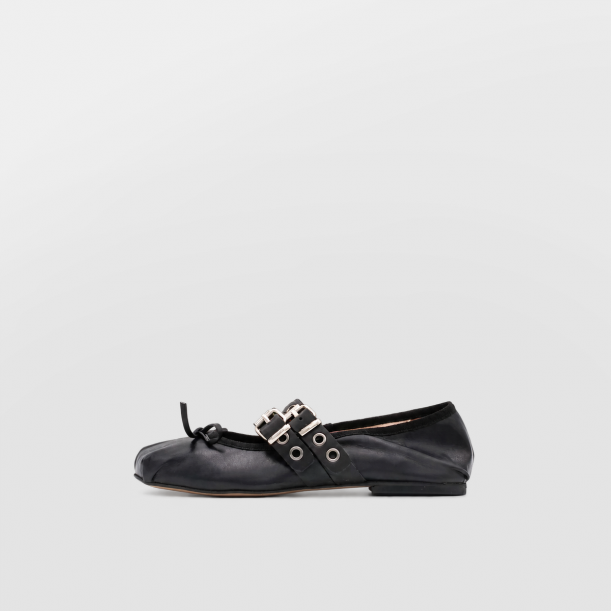 Clara black ballet flat shown alone in profile, double buckle strap with eyelets and a small bow