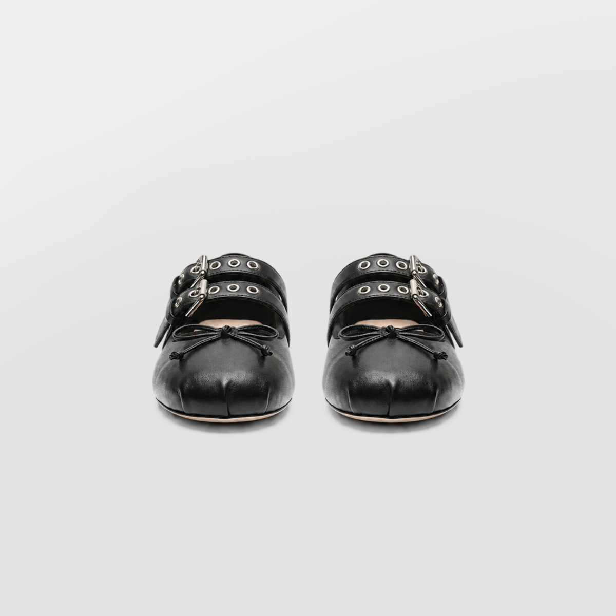 Front view of both black Clara ballet flats showing the twin straps and bows
