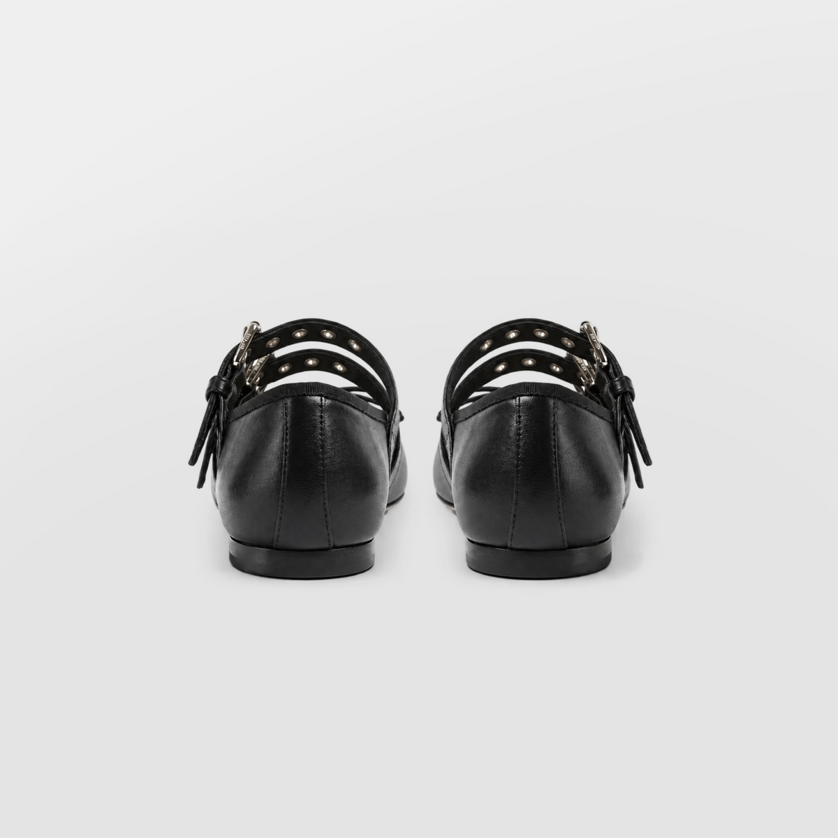 Back view of the black buckle ballet flats standing side by side