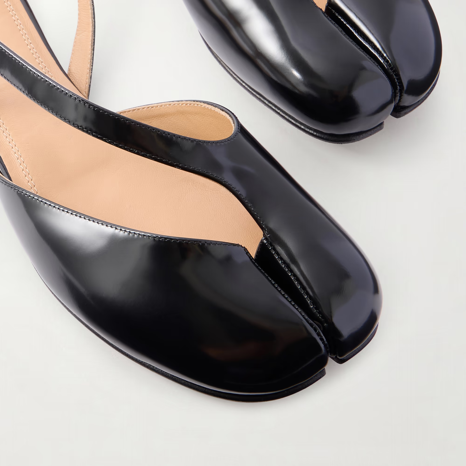 Close-up of silver hardware buckle on black patent leather slingback shoes by lil cacti