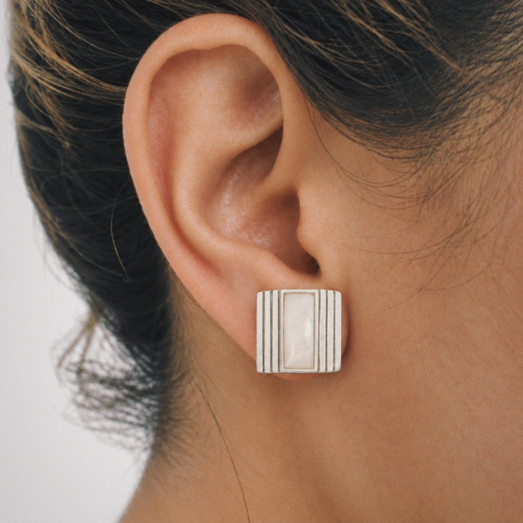 Model wearing Lil Cacti Column Square Stud Earrings, close crop on the detail