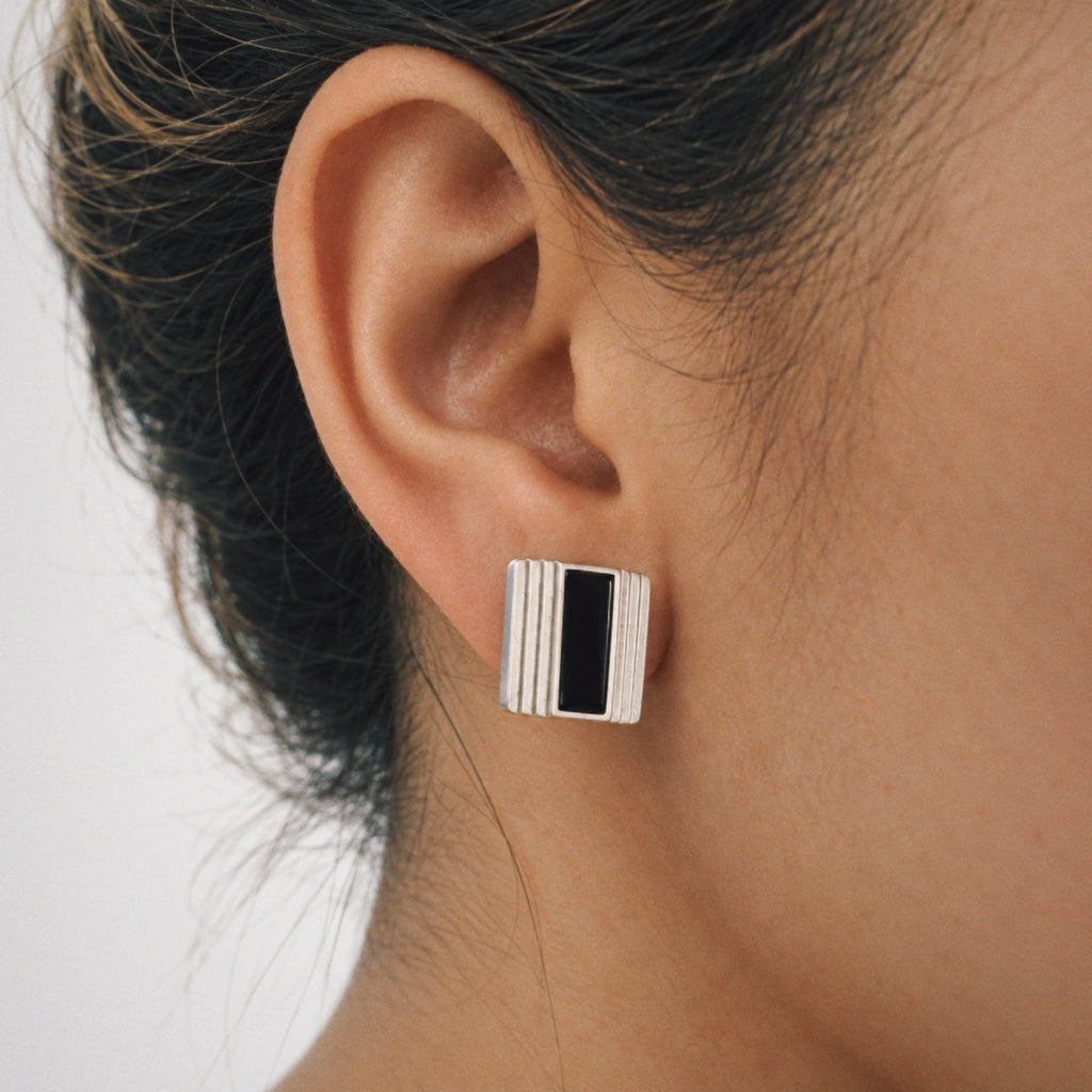 Model wearing the Column Square Stud Earrings from a side angle