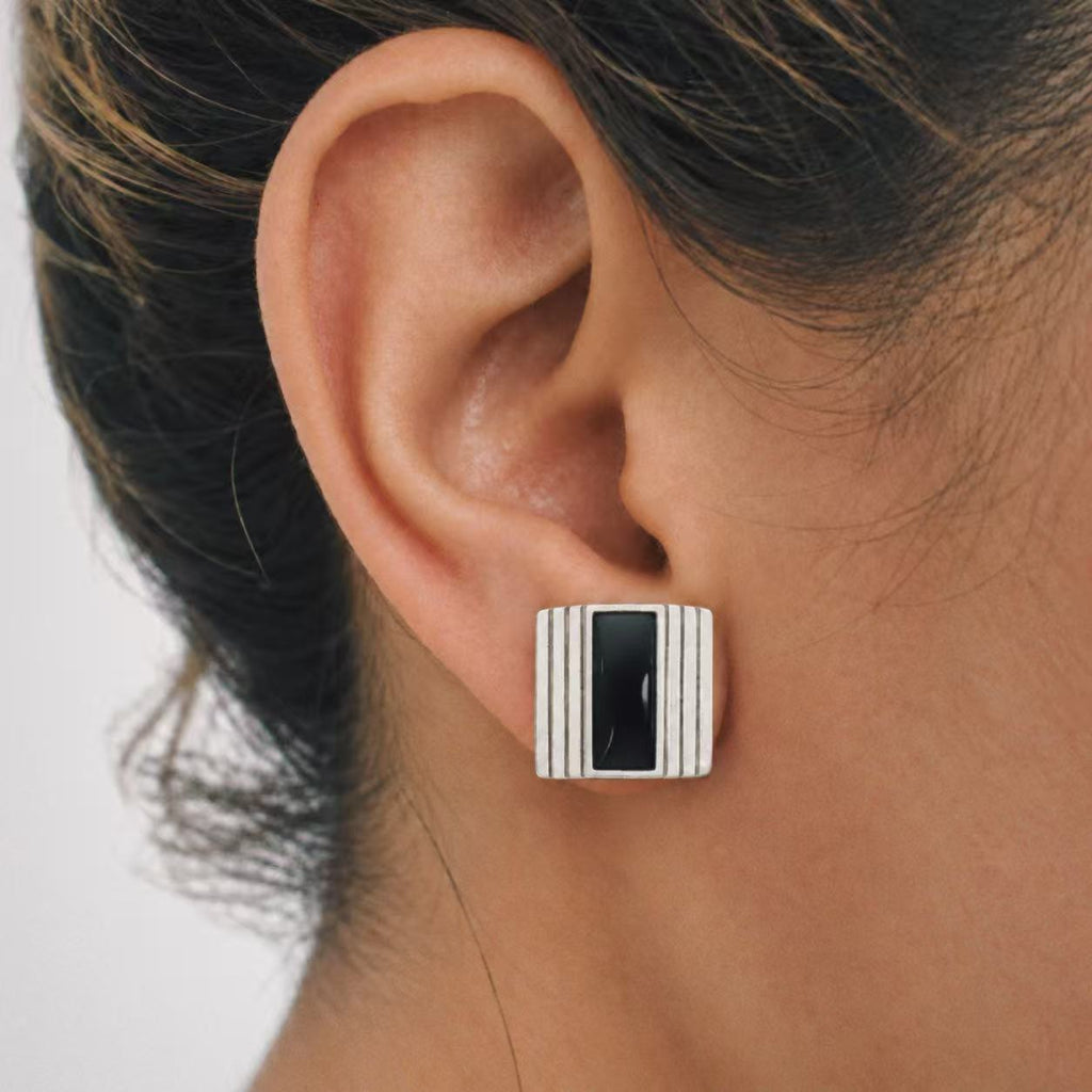 Model wearing the Column Square Stud Earrings in soft daylight
