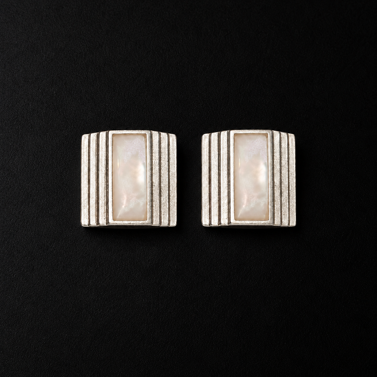 Pair of Column Square Stud Earrings angled together on a dark background