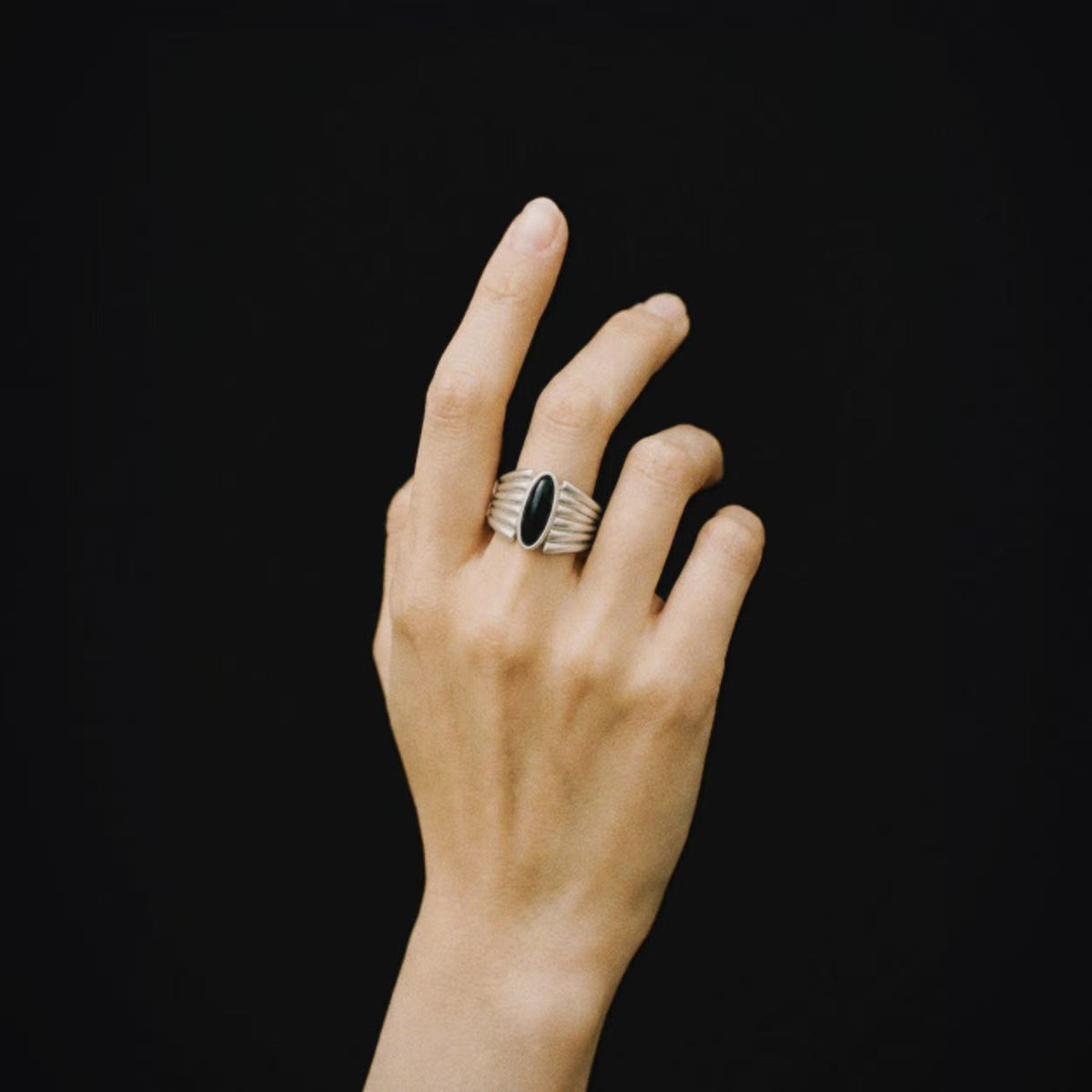 Model wearing Lil Cacti Corvid Fluted Signet Ring, close crop on the detail