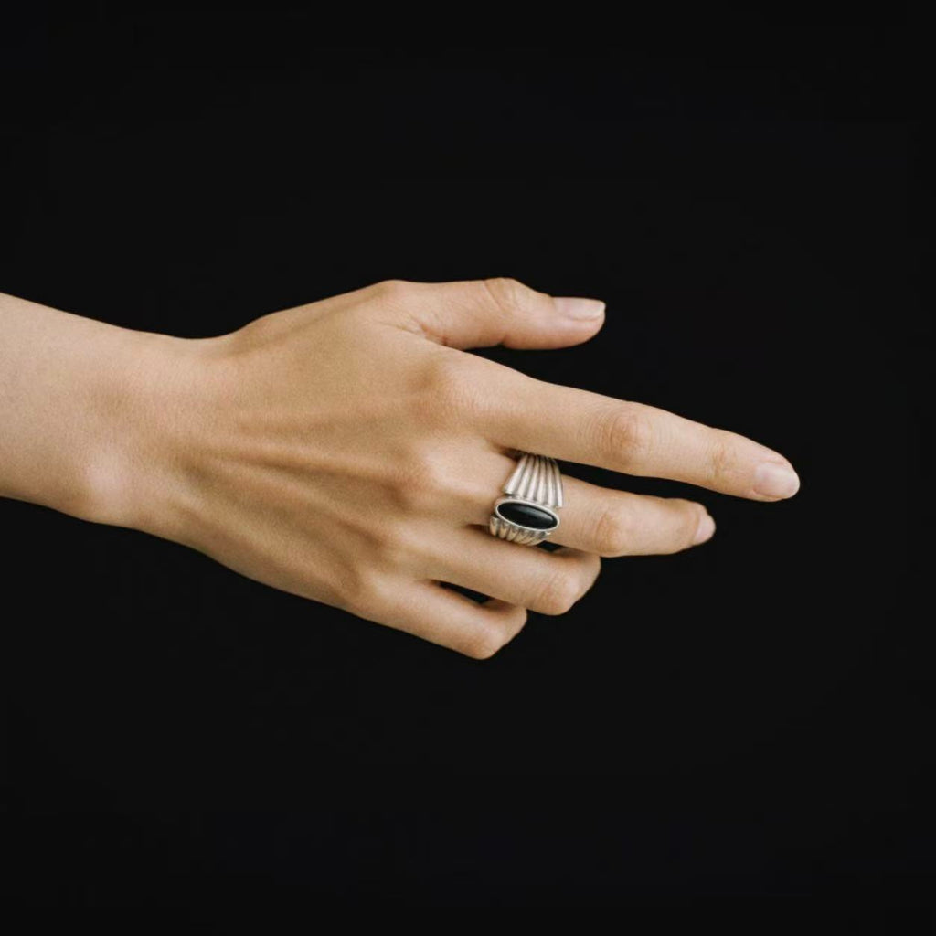 Model wearing the Corvid Fluted Signet Ring from a side angle