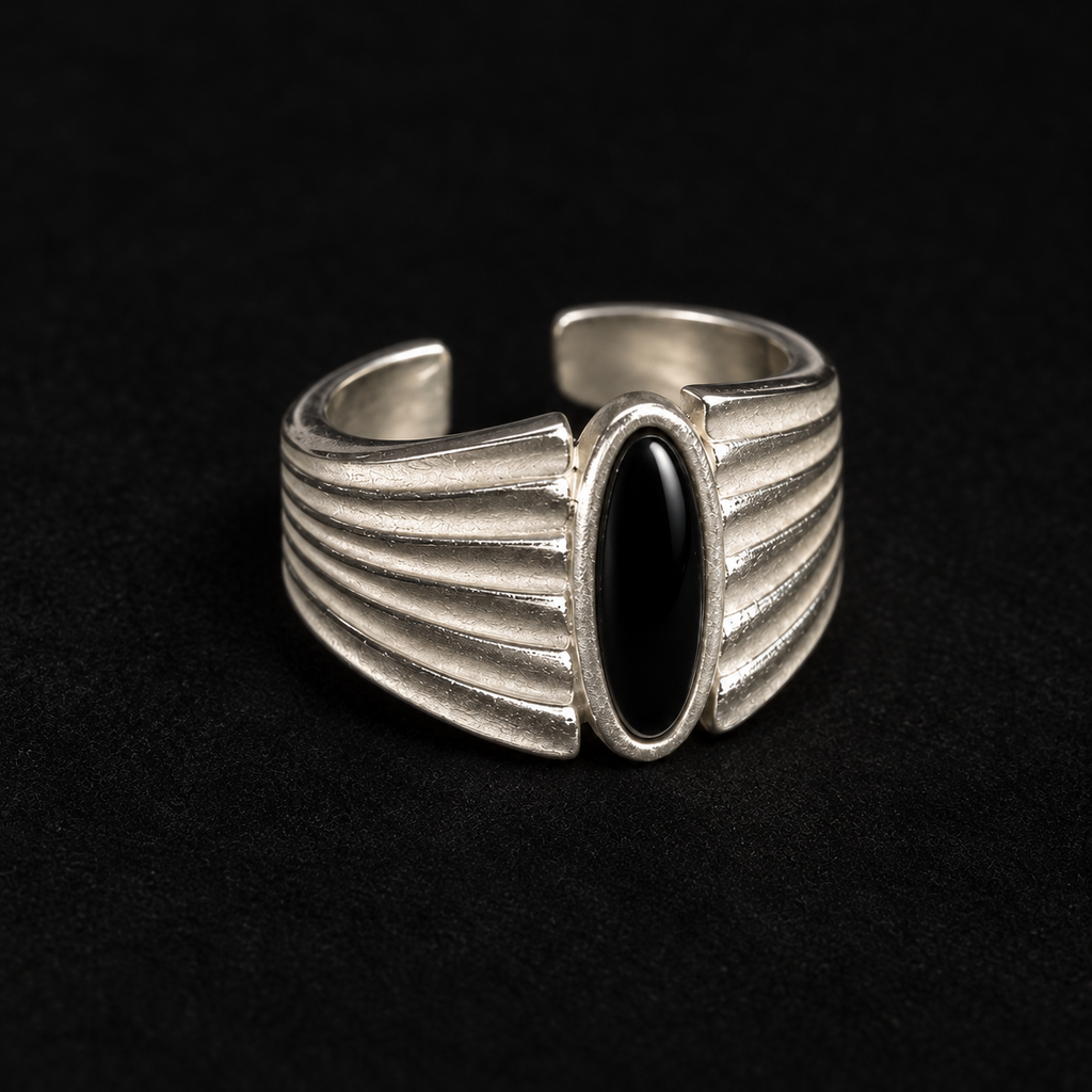 Pair of Corvid Fluted Signet Ring angled together on a dark background