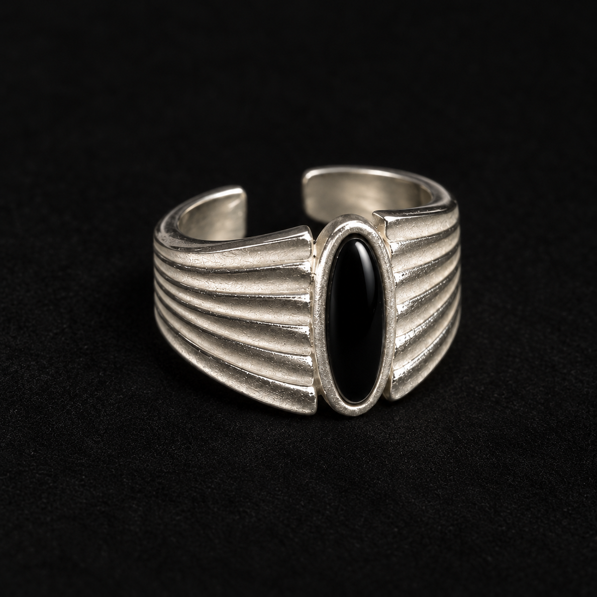 Pair of Corvid Fluted Signet Ring angled together on a dark background