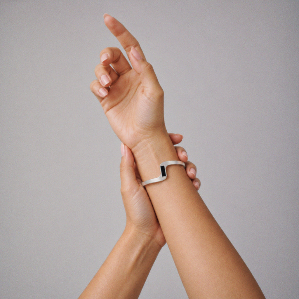 Model wearing the Crest Wave Cuff Bracelet, three quarter view