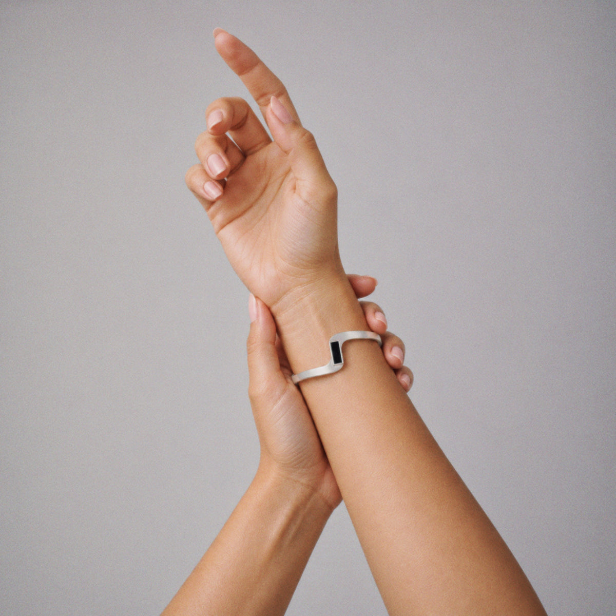 Model wearing the Crest Wave Cuff Bracelet, three quarter view