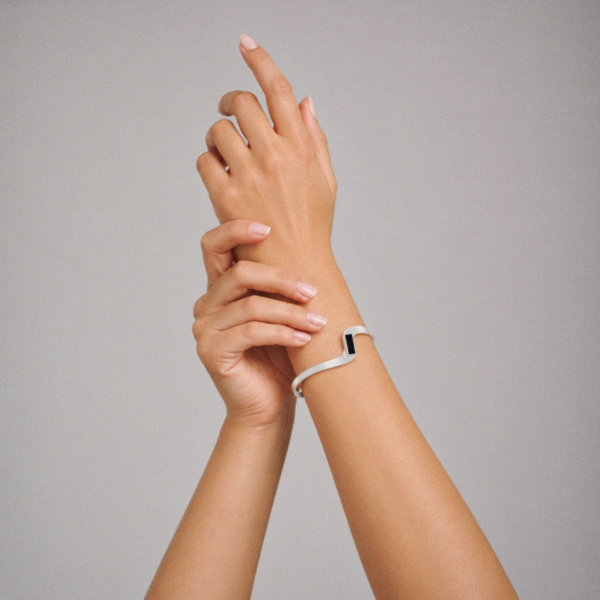 Model wearing the Crest Wave Cuff Bracelet in soft daylight