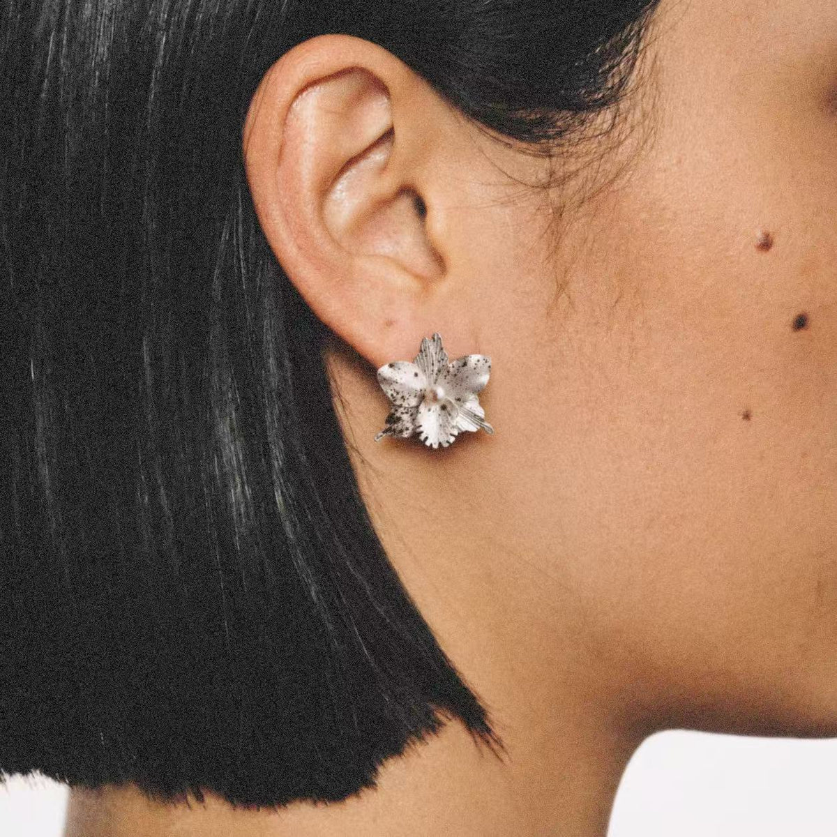 Model wearing the Crushed Orchid Earrings seen from the front