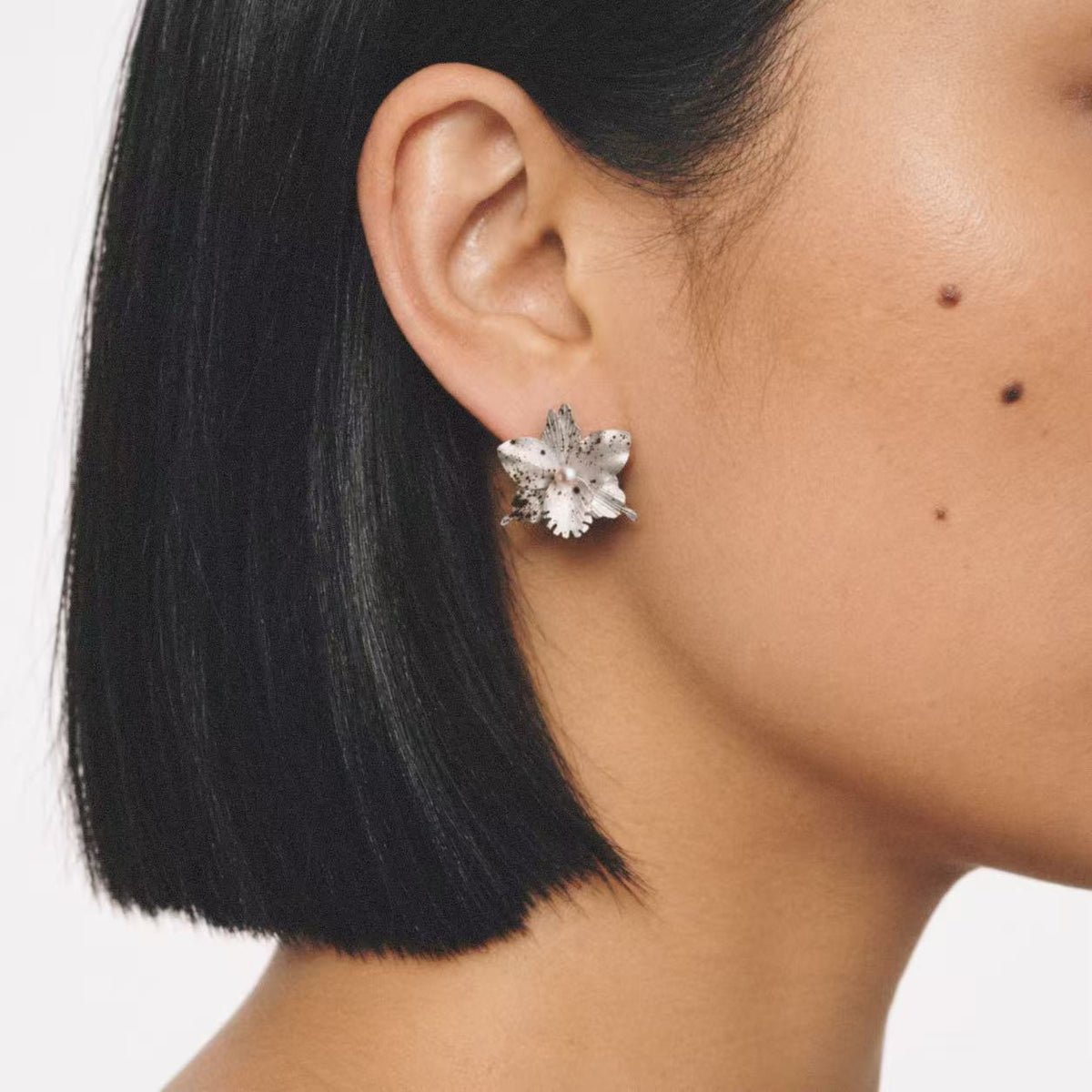 Model wearing the Crushed Orchid Earrings seen from the side