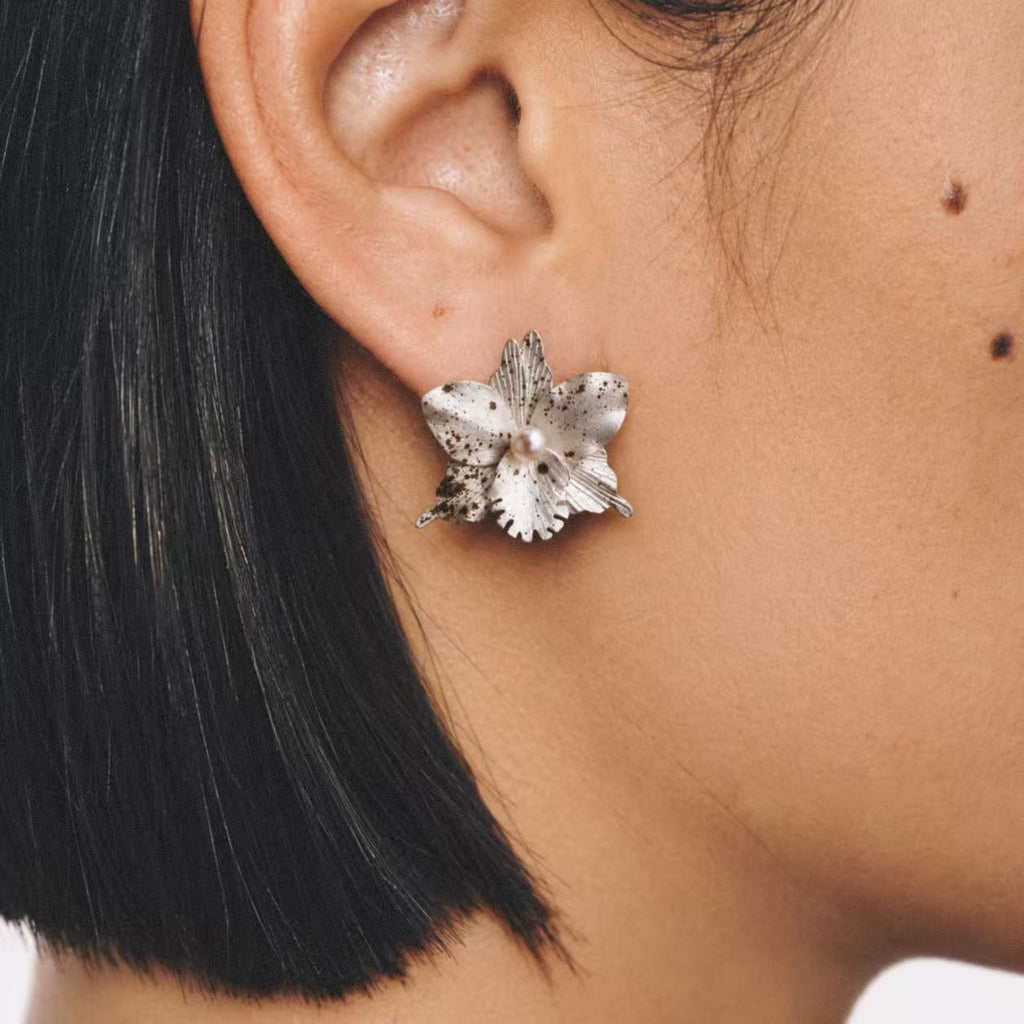 Model wearing the Crushed Orchid Earrings in a close crop