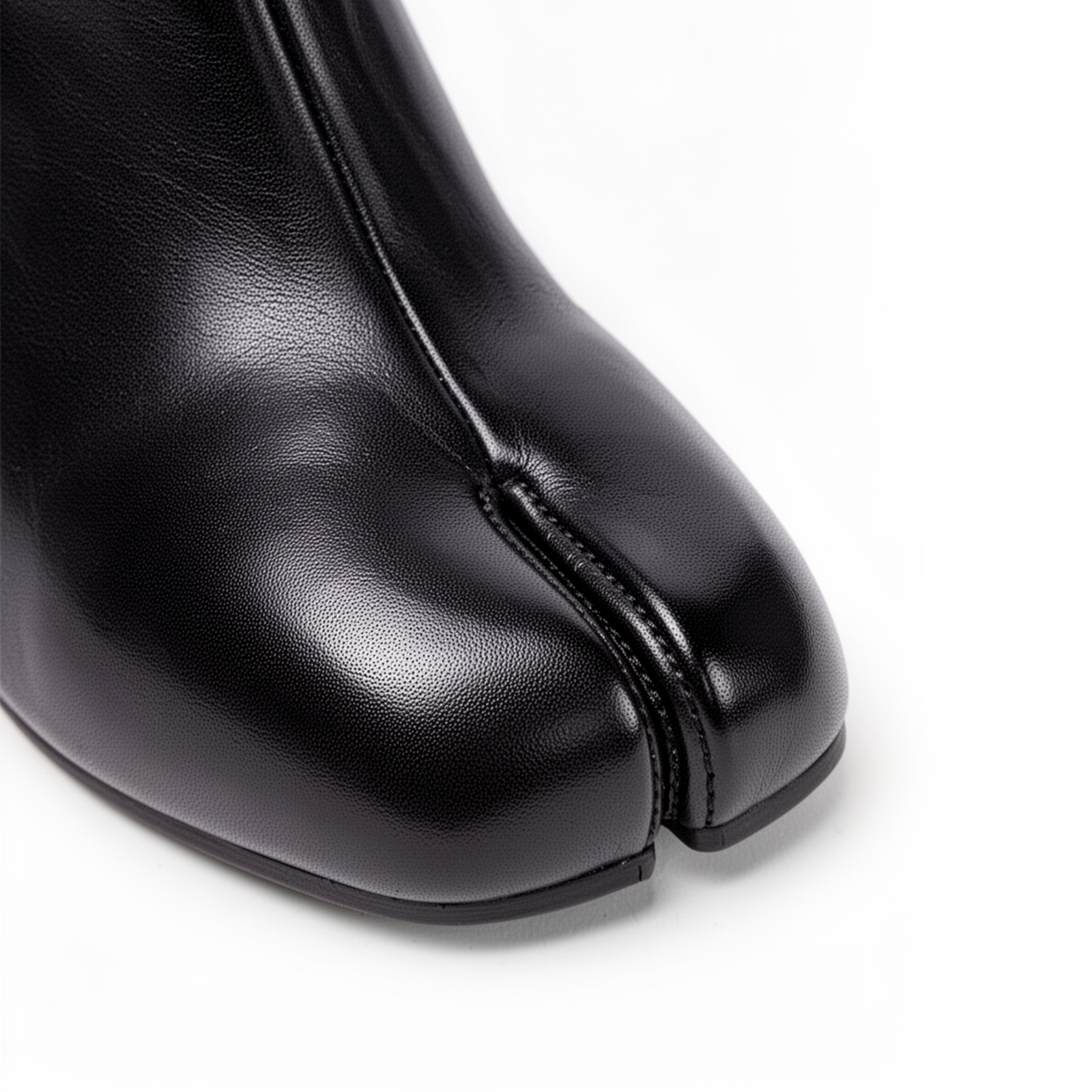 Close-up of split-toe tabi detail on Daria black leather boots
