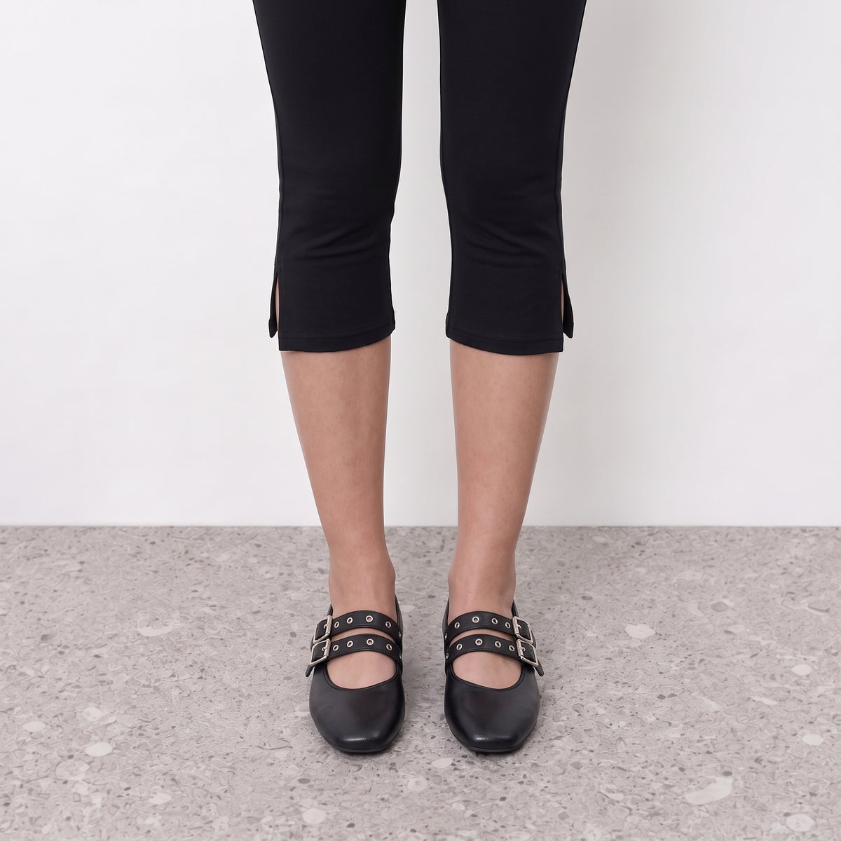 Front view on the foot of black mary jane flats with twin eyelet straps