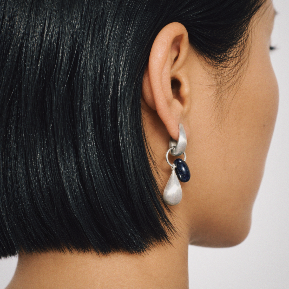 Model wearing Dew Teardrop Charm Hoop Earrings by Lil Cacti, view 4