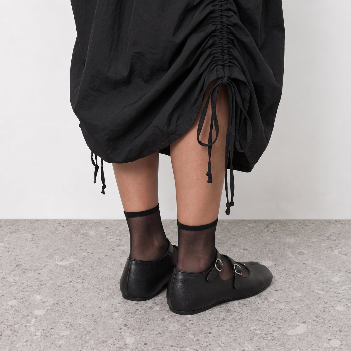 Model standing in Lil Cacti double strap tabi mary janes on a stone floor