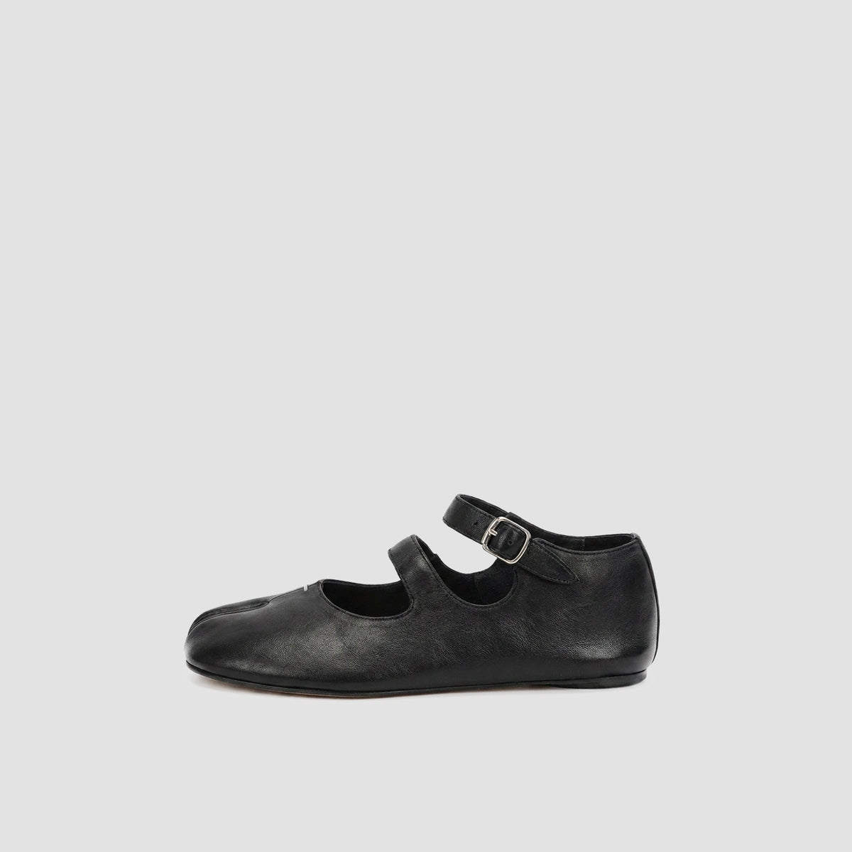 Black double strap tabi mary jane flat shown alone in profile with two buckled straps