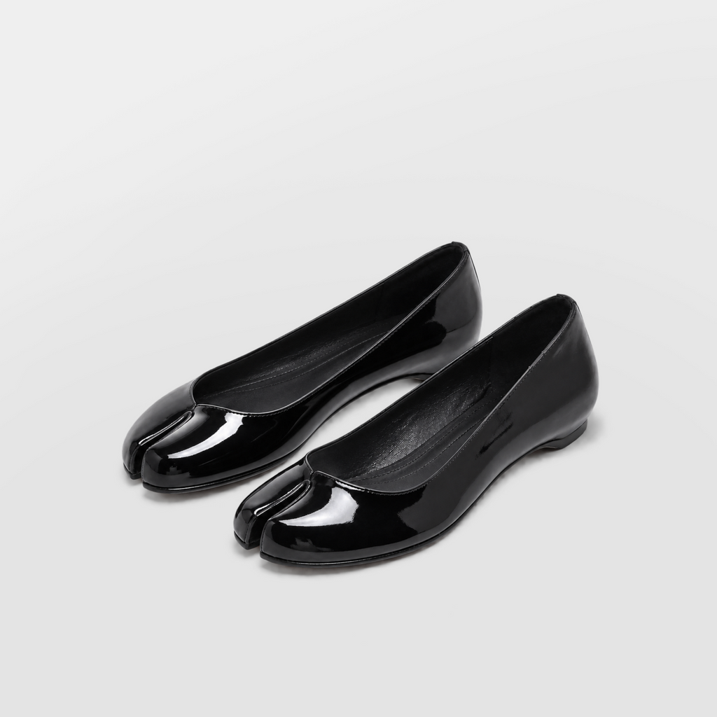 Echo Tabi Flats by Lil Cacti — black patent pair at a three-quarter angle, split toe and black lining