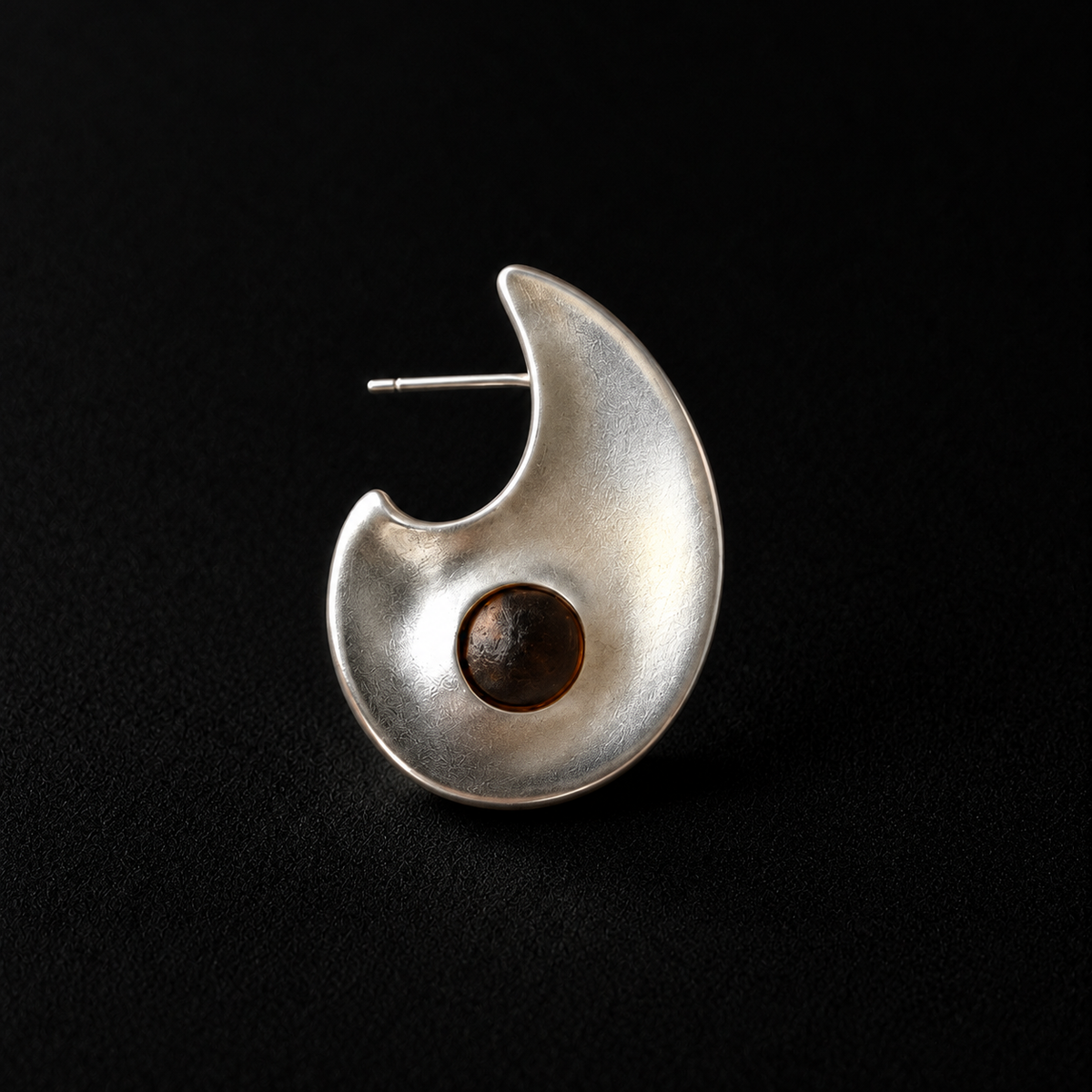 Pair of Eclipse Crescent Stud Earrings angled together on a dark background