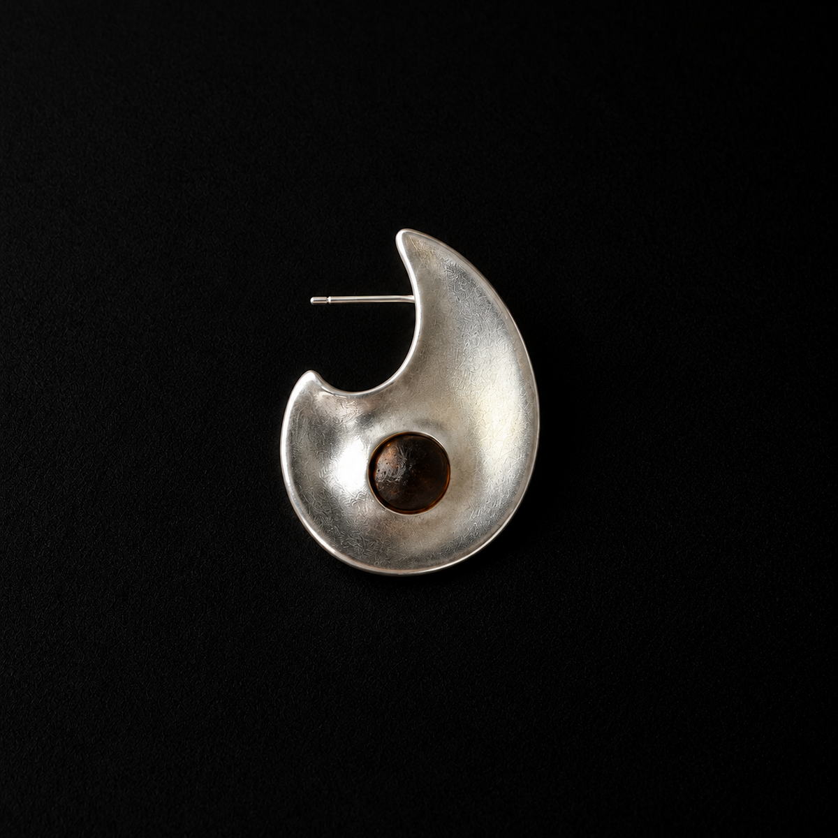 Close detail of the Eclipse Crescent Stud Earrings surface and finish