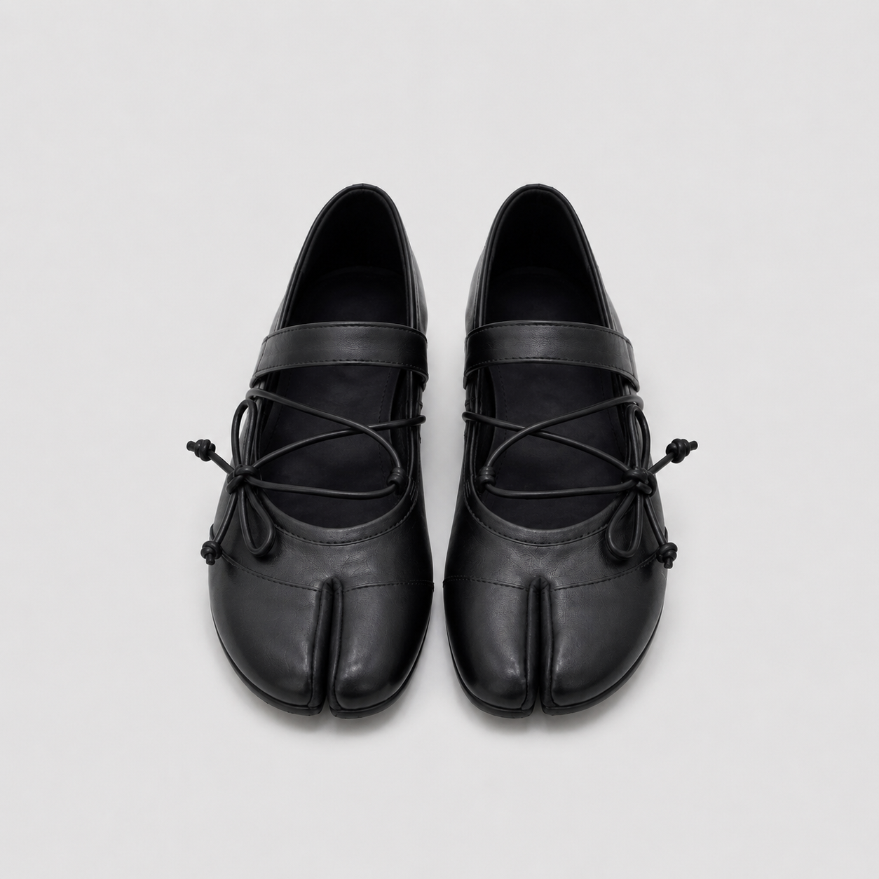 Rear view of black lace-up ballet flats showing the plain low heel