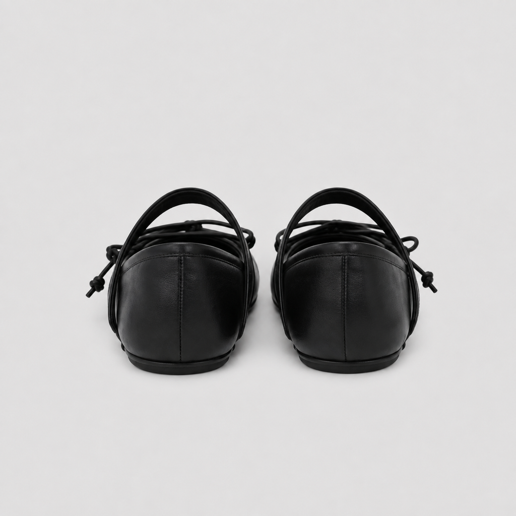 Front view of black tabi flats with the split toe and lacing clearly visible