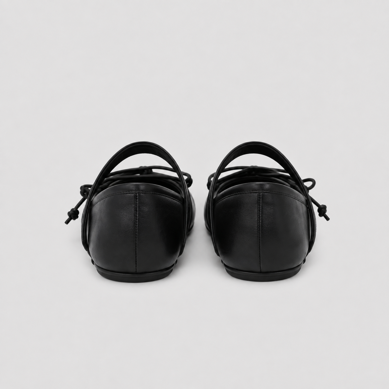 Front view of black tabi flats with the split toe and lacing clearly visible