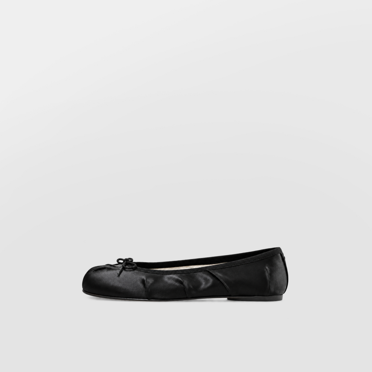 Evelyne Black Satin Tabi Ballet Flats by Lil Cacti — side profile of one flat with gathered satin vamp, bow and flat sole