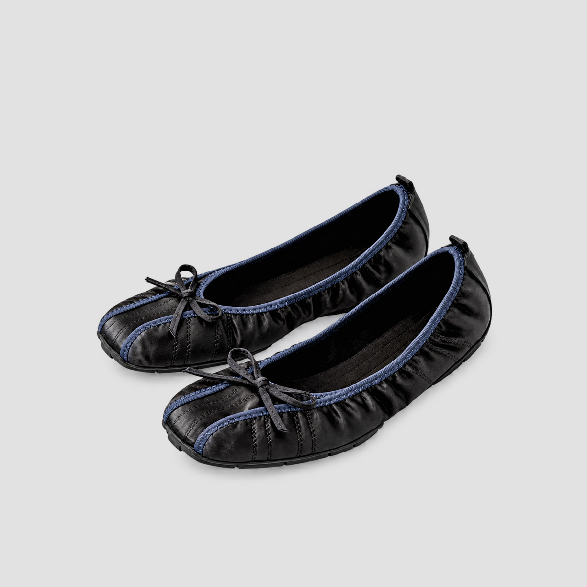 Pair of Faye Ruched Bow Ballet Flats in black, shown from a forty-five-degree angle