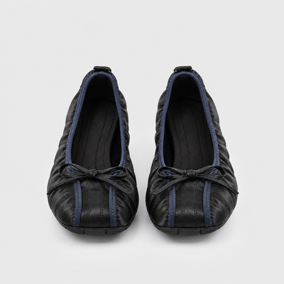 Front view of both Faye Ruched Bow Ballet Flats in black, showing toe shape