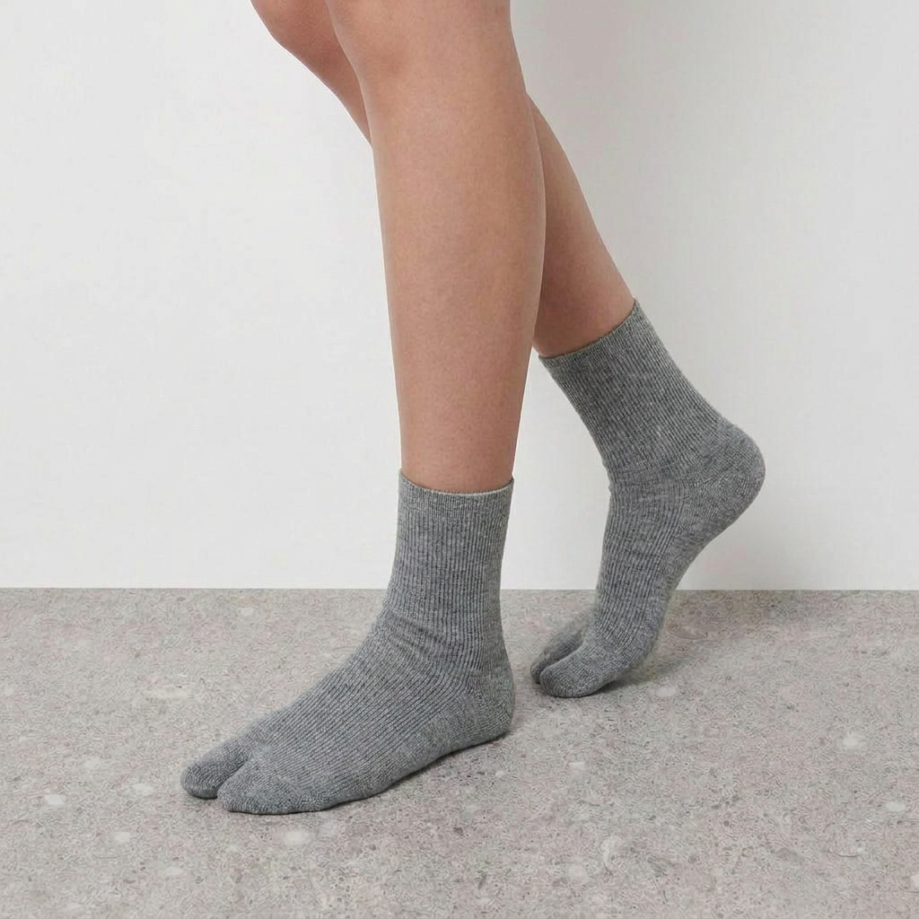 Mid Calf Tabi Socks by Lil Cacti — heather gray pair on model, side profile, back foot raised on tiptoe