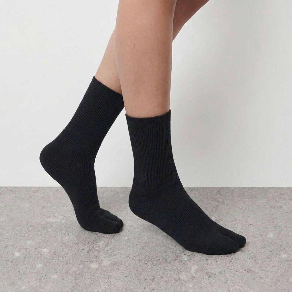 Mid Calf Tabi Socks by Lil Cacti — black pair on model, side profile with front foot pointed to show the ribbed knit