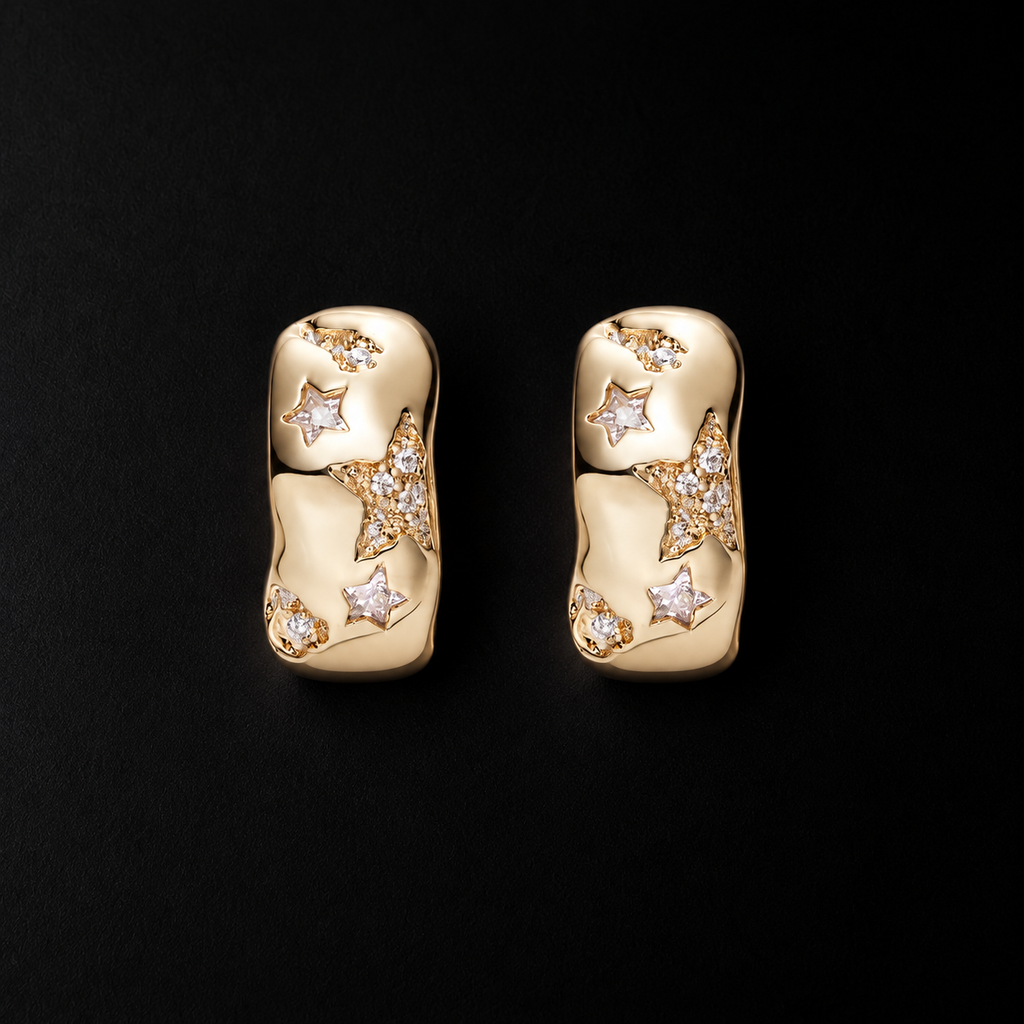 Lil Cacti star huggie earrings with celestial details on a dark background