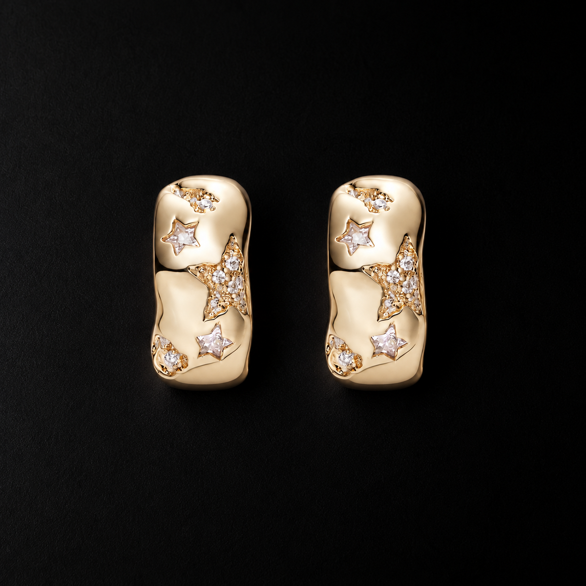 Lil Cacti star huggie earrings with celestial details on a dark background